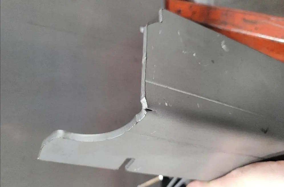 Pictures FIGURE 2. Cracking near a laser-cut edge can be caused by hardness issues resulting from an inadequate HAZ, combined with variations in material characteristics, especially considering that previous batches of parts were bent successfully.