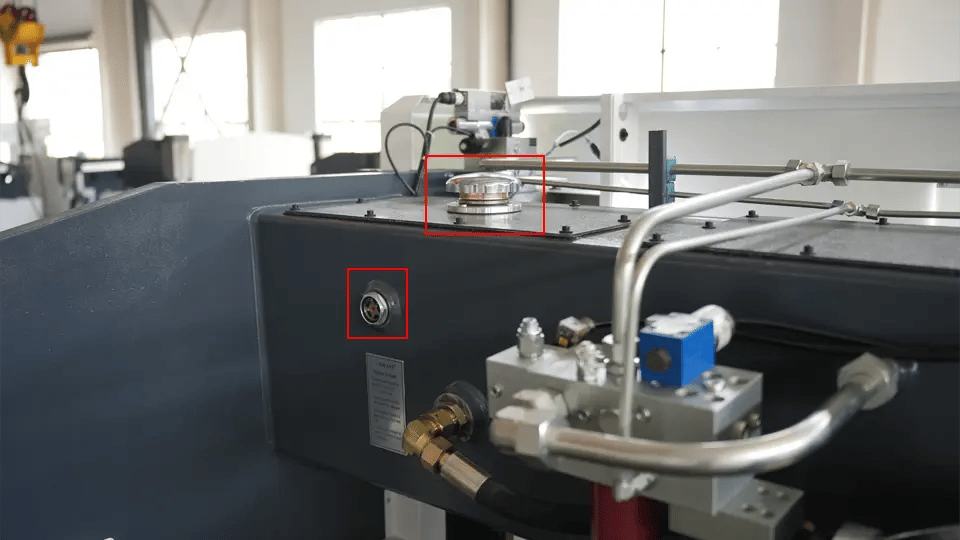 KRRASS press brake hydraulic oil filler port (upper right) and inspection port (lower left)