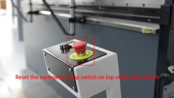 Reset the emergency stop switch on top of the foot switch