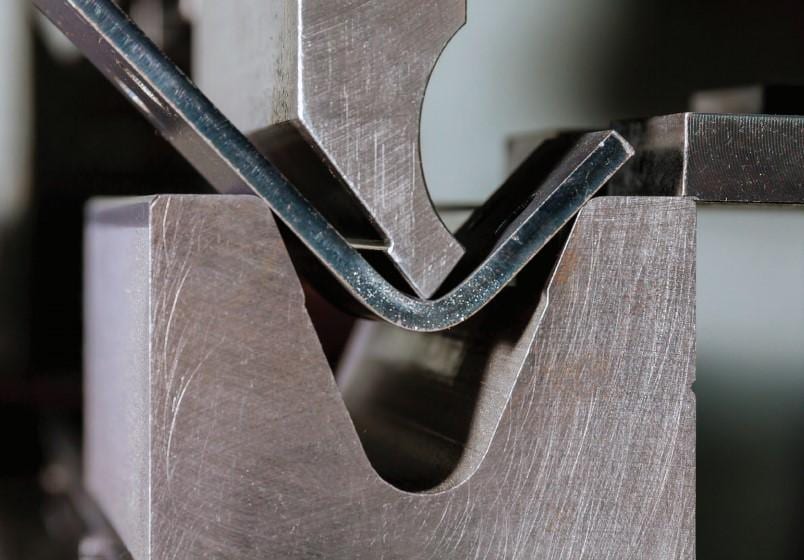 Pictures FIGURE 8 In air bending, the die opening establishes the radius and the punch's depth of penetration into the die space establishes the bend angle. This further demonstrates how crucial it is to keep the flange length at a minimum. This bend might not fit firmly on the die if it were nearer the plate edge.