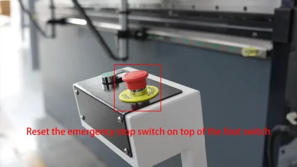 Reset the emergency stop switch on top of the foot switch