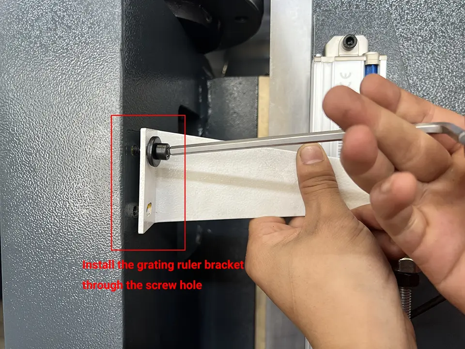 Install the grating ruler bracket through the screw hole