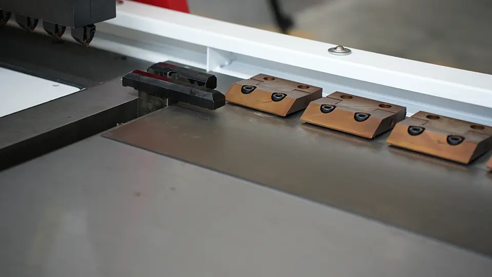 Place the metal plate close to the edge of the workbench